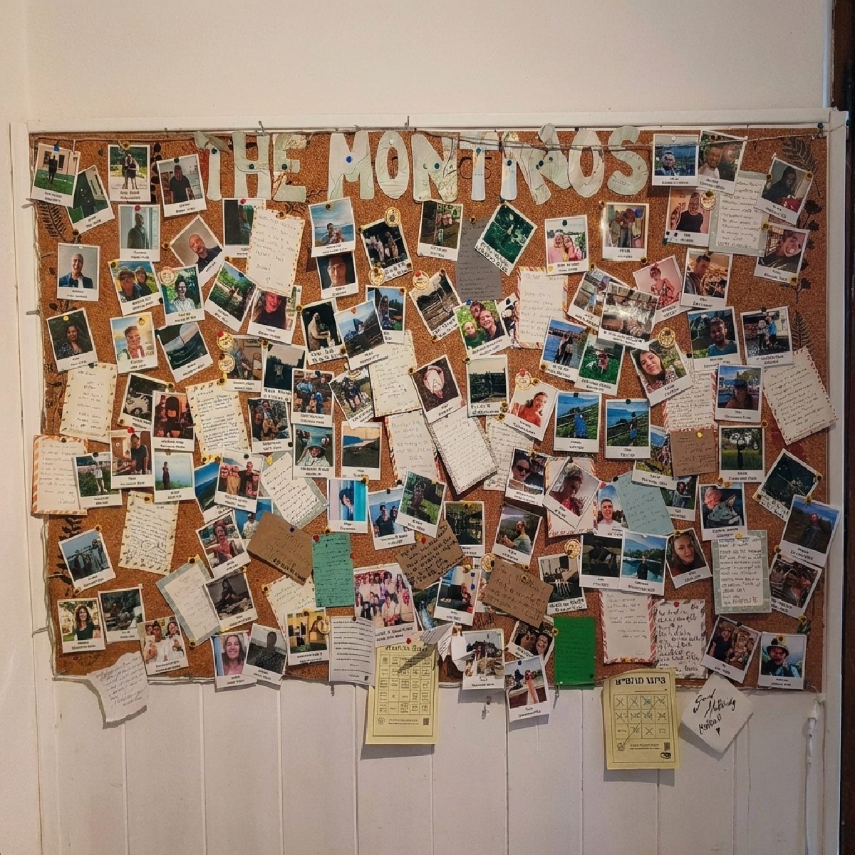 The Montinos board by the front door, covered with photos of guests who have stayed